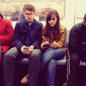 rob and mary looking at phones on the subway